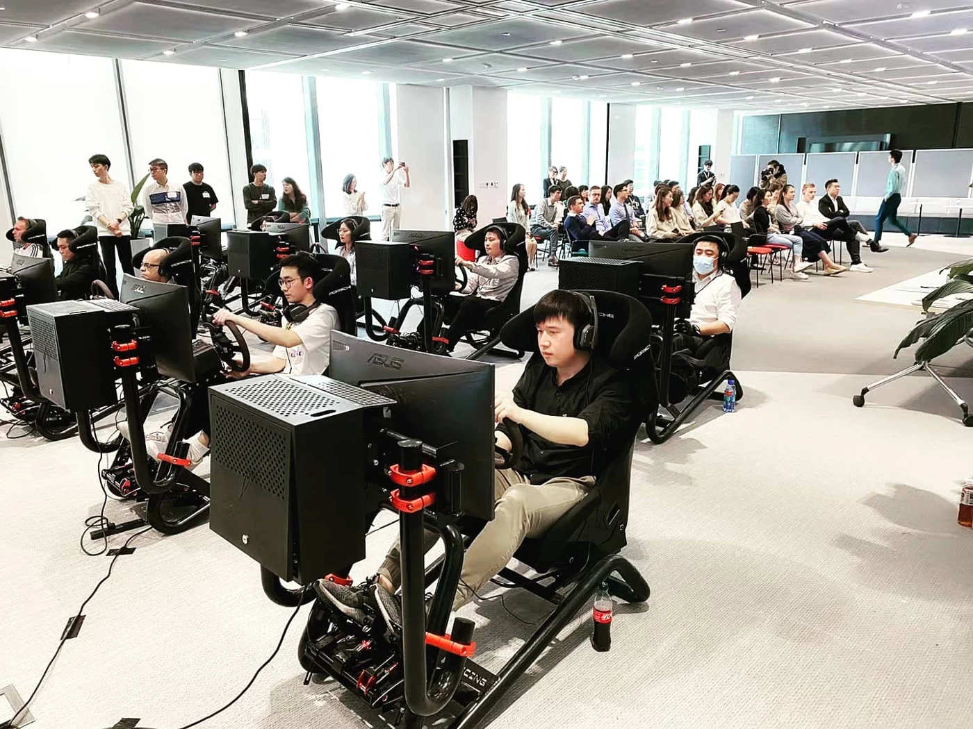 Participants driving multiple simulator stations at an event