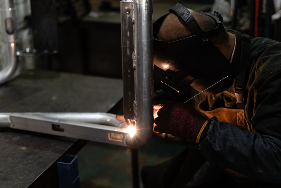 A welder TIG welding an AZRACING simulator frame