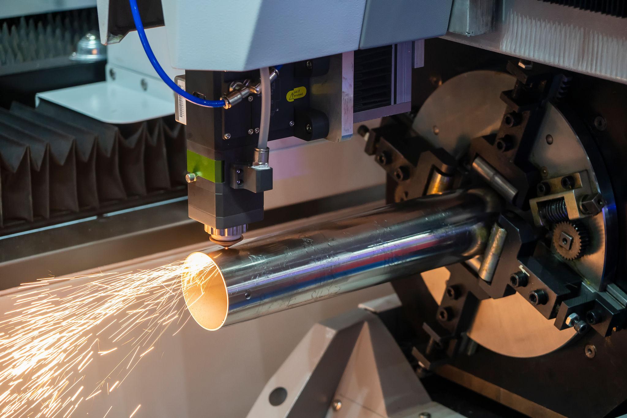 Laser tube cutting equipment cutting a metal tube
