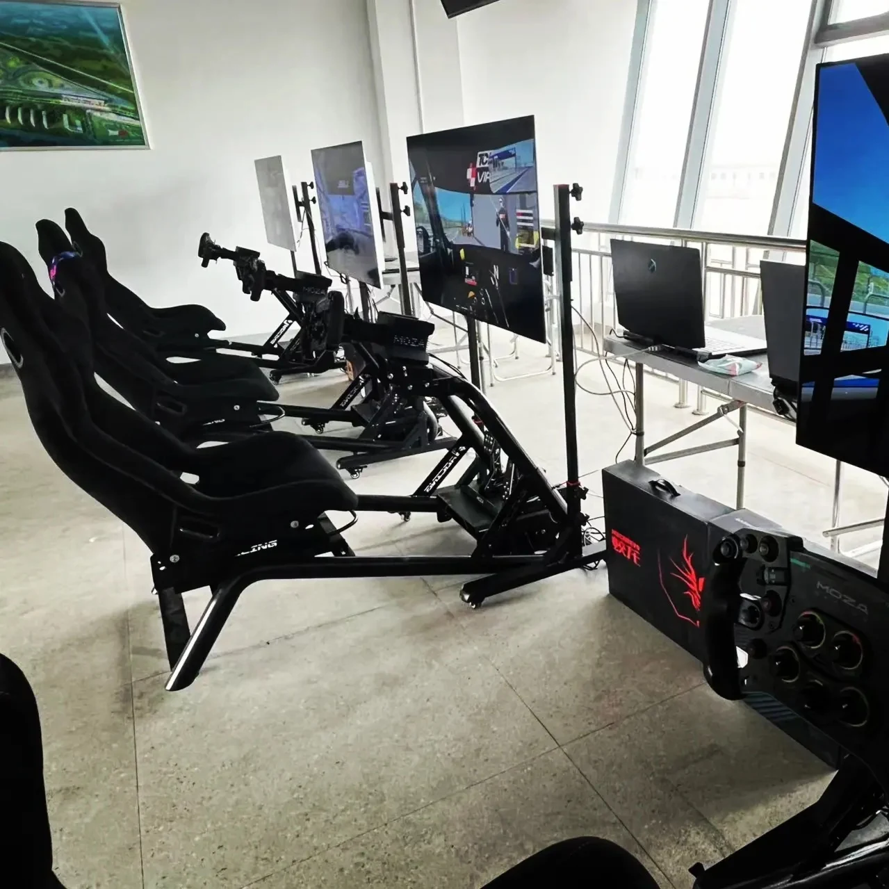 Several AZRACING cockpit setups arranged in a simulator space